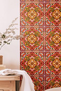 the wall is decorated with colorful tiles and flowers