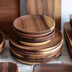 a stack of wooden plates sitting on top of a table next to other wood pieces