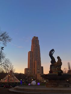 a statue in front of a tall building