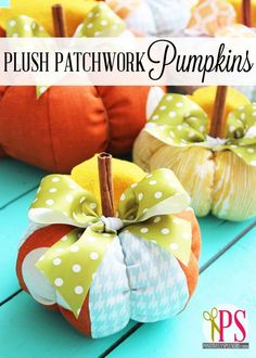 small pumpkins with bows on them sitting on a table