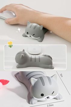 a hand holding a computer mouse next to a cat shaped object