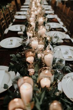 a long table is set with candles and plates