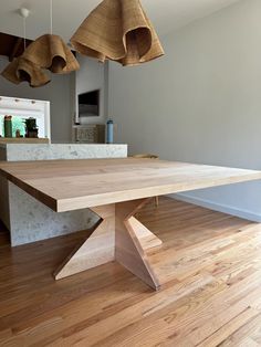 a large wooden table sitting on top of a hard wood floor