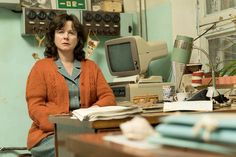 a woman sitting at a desk in an office