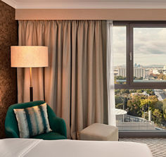 a hotel room with a view of the city