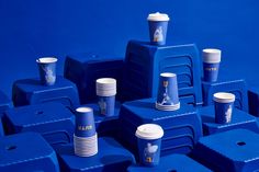 many blue cups are stacked on top of each other