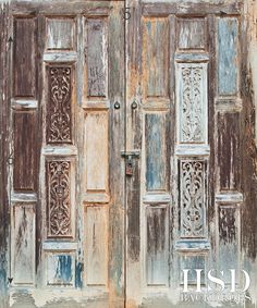 an old wooden door with intricate carvings on the doors and side panels is painted blue