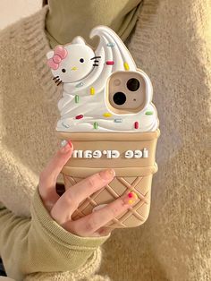 a woman holding up an ice cream phone case