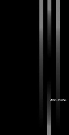 an abstract black and white photo with vertical lines in the middle, on a dark background