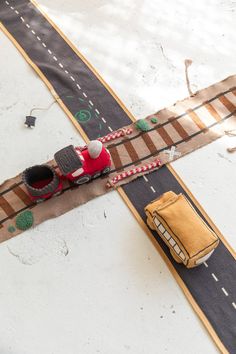 an overhead view of a toy car on a track with cars going down the road