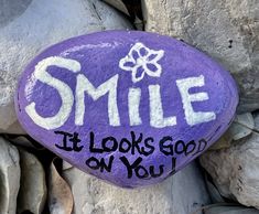 a purple rock that says smile it looks good on you