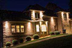 a house that is lit up at night with some lights on it's windows