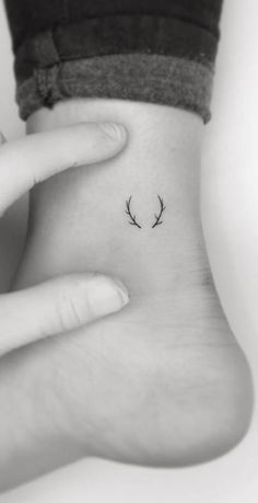 a woman's foot with two small antlers on the middle of her ankle