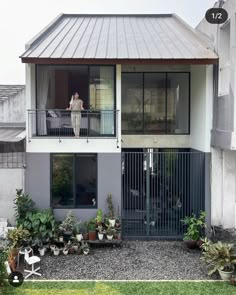 a person standing on the balcony of a house