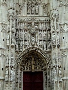 an ornate door with statues on it