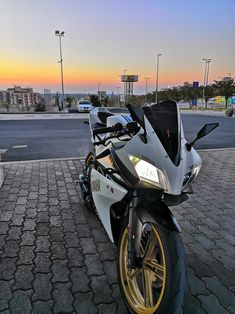 a white and black motorcycle parked on the street