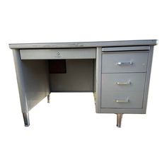 an office desk with three drawers on one side and two doors at the other end