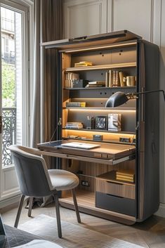 a desk and chair in front of a window with open shelves on the wall next to it