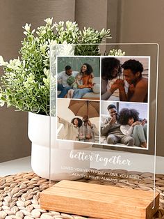 a vase with some flowers in it sitting on a table next to a plaque that says, better together