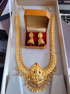 a necklace and earring set in a box