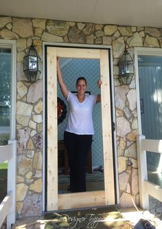 a woman standing in front of a door with her arms up