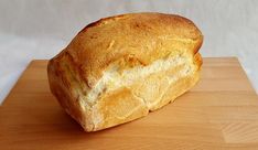 a loaf of bread sitting on top of a wooden cutting board