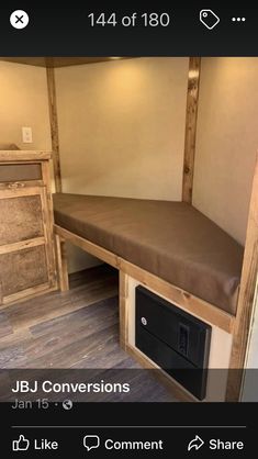 a small room with a bed and drawers