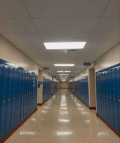 a long hallway with several blue lockers in it