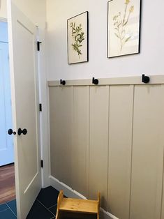 a wooden step stool sitting next to a white door