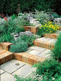 an outdoor garden with brick steps and flowers