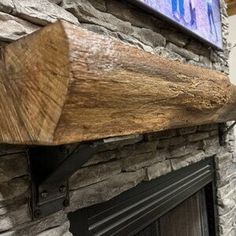 a stone fireplace with a wooden mantle