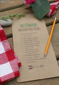 an out door adventure hunt is displayed on a picnic table with a pencil and napkin