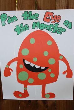 a sign that says pin the eye on the monster with an orange and green polka dot design