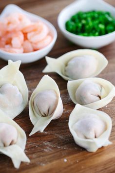 some dumplings are sitting on a wooden table