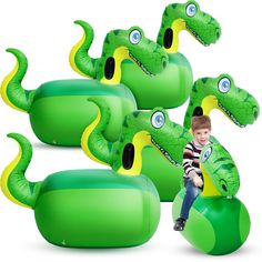 a young boy sitting on an inflatable green and yellow toy with large eyes