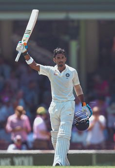 a man holding a cricket bat and ball in his hand