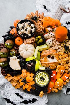 a halloween snack board with pumpkins, jack - o'- lanterns and candy treats