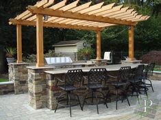 an outdoor kitchen and dining area is shown