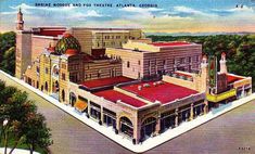 an old postcard shows the main street in front of some buildings with red roofs