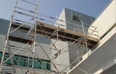 scaffolding on the side of a building being worked on