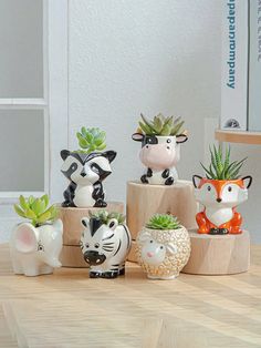 small ceramic animal planters are sitting on a table