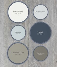 six different colors of paint with the names of each product on them, including white and gray