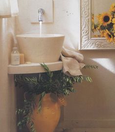 a bathroom sink with sunflowers in the background