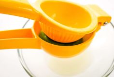 a yellow measuring cup with two spoons in it