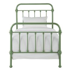 a green metal bed with white sheets and pillows