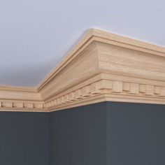 the corner of an empty room with molding on the wall and ceiling above it