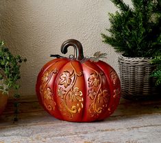 a red pumpkin sitting on top of a wooden table