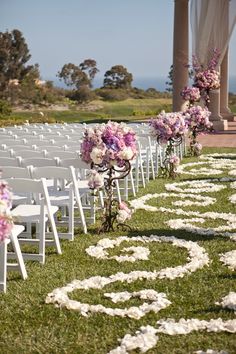 the wedding aisle is decorated with flowers and petals