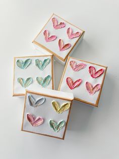 four decorated cookies in the shape of hearts