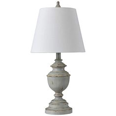 a white table lamp with a white shade on it